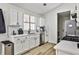 Well-lit kitchen with stainless steel appliances, white cabinets, and stylish subway tile at 3915 Basil Sw Way, Atlanta, GA 30331