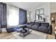 Stylish living room featuring a large sofa, light wood flooring, and modern decor at 3915 Basil Sw Way, Atlanta, GA 30331