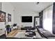 Modern living room with a sleek TV, contemporary art, light wood flooring and plush seating at 3915 Basil Sw Way, Atlanta, GA 30331