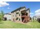 Grassy backyard with a stone patio, wooden deck, and secure fencing provides ample space at 5780 Winding Lakes Dr, Cumming, GA 30028