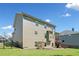 Spacious backyard features lush green grass, a small patio, wood deck, and secure perimeter fencing at 5780 Winding Lakes Dr, Cumming, GA 30028