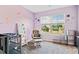 Bright bedroom features gray carpet, pastel colors, and a window with outside view at 5780 Winding Lakes Dr, Cumming, GA 30028