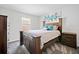Bedroom with a rustic wood bed frame, carpet, and matching nightstand and dresser at 5780 Winding Lakes Dr, Cumming, GA 30028