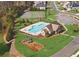 Aerial view showcases a pool, playground, and tennis courts in a well-maintained community at 5780 Winding Lakes Dr, Cumming, GA 30028