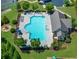 Aerial shot of community pool surrounded by lounge chairs, landscaping, and a clubhouse at 5780 Winding Lakes Dr, Cumming, GA 30028