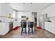 Modern kitchen with white cabinets, stainless steel appliances, granite countertops, and bar stool seating at 5780 Winding Lakes Dr, Cumming, GA 30028