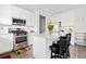 Bright kitchen with white cabinetry, stainless steel appliances, and a granite island with bar stools at 5780 Winding Lakes Dr, Cumming, GA 30028