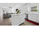 Bright kitchen with white cabinetry, stainless steel appliances, an island, and open access to living space at 5780 Winding Lakes Dr, Cumming, GA 30028