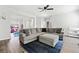 Comfortable living room with a large sectional sofa, a blue rug, and plenty of natural light at 5780 Winding Lakes Dr, Cumming, GA 30028