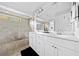 Bright bathroom featuring double sinks, ample cabinet space, and a tiled shower at 5780 Winding Lakes Dr, Cumming, GA 30028