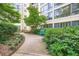 Secluded courtyard view showcasing well-maintained greenery, a bench, and a tranquil walkway at 1800 Clairmont Lk # A310, Decatur, GA 30033