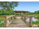 Wooden dock featuring a gazebo extending over a tranquil lake, surrounded by lush greenery at 1800 Clairmont Lk # A310, Decatur, GA 30033