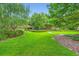 Beautifully landscaped front yard with lush green grass and mature trees creating a serene outdoor space at 1800 Clairmont Lk # A310, Decatur, GA 30033