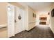 Well-lit hallway leading to unit 310 with neutral paint, carpet, and decorative wall art at 1800 Clairmont Lk # A310, Decatur, GA 30033