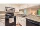Kitchen featuring granite countertops, stainless appliances, and white cabinetry at 1800 Clairmont Lk # A310, Decatur, GA 30033