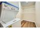 Stacked washer and dryer with shelving inside laundry area at 1800 Clairmont Lk # A310, Decatur, GA 30033
