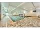 Indoor pool area featuring well-maintained pool, tiled flooring, and large windows for natural lighting at 1800 Clairmont Lk # A310, Decatur, GA 30033