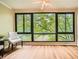 Sunroom with hardwood floors, ceiling fan, and large windows with lush green views at 1800 Clairmont Lk # A310, Decatur, GA 30033
