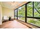 Sunroom with hardwood floors, ceiling fan, and large windows with lush green views at 1800 Clairmont Lk # A310, Decatur, GA 30033