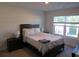 Cozy bedroom with a comfortable bed, dark wood furniture, and a bright window view at 3411 Swallowtail Ter, Duluth, GA 30096