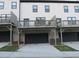 Exterior showing multi-level decks and garage access for each unit at 3411 Swallowtail Ter, Duluth, GA 30096
