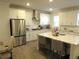 Modern kitchen featuring stainless steel appliances, white cabinets, and a kitchen island with barstool seating at 3411 Swallowtail Ter, Duluth, GA 30096