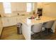Bright kitchen featuring white cabinets, granite countertops, stainless steel appliances, and an island with seating at 3411 Swallowtail Ter, Duluth, GA 30096