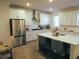 Modern kitchen with stainless steel appliances and breakfast bar seating at 3411 Swallowtail Ter, Duluth, GA 30096