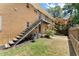 Apartment building featuring brick exterior, stairs to upper units, and green backyard space at 3510 Roswell Nw Rd # N3, Atlanta, GA 30305