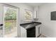 Well-lit kitchen with white cabinets, black appliances, and direct access to the outdoors at 3510 Roswell Nw Rd # N3, Atlanta, GA 30305