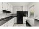 Efficient kitchen with white cabinets, sleek black appliances, and modern tile flooring at 3510 Roswell Nw Rd # N3, Atlanta, GA 30305
