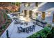Stunning backyard patio with outdoor kitchen, dining area, lounge seating, and lush landscaping perfect for entertaining at 6090 River Chase Cir, Atlanta, GA 30328
