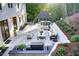Expansive backyard patio features an outdoor kitchen, dining area, cozy seating around a fire pit, and beautiful landscaping at 6090 River Chase Cir, Atlanta, GA 30328