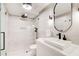 Modern bathroom features a sleek walk-in shower with black fixtures, a stylish sink, and contemporary design elements at 6090 River Chase Cir, Atlanta, GA 30328