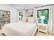 Cozy bedroom featuring neutral colors, a comfortable bed, large windows, a built-in bookshelf, and hardwood floors at 6090 River Chase Cir, Atlanta, GA 30328