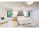 Bright bedroom featuring hardwood floors, large windows, neutral decor, a plush rug, and a cozy sitting area at 6090 River Chase Cir, Atlanta, GA 30328