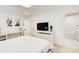 Bright bedroom with hardwood floors, art, and TV. Open doorway to bathroom at 6090 River Chase Cir, Atlanta, GA 30328