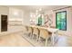 Bright dining room with seating for eight, modern lighting, wine cooler, and elegant decor at 6090 River Chase Cir, Atlanta, GA 30328