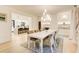 Open dining room with a view of the kitchen, modern lighting, seating for eight, and stylish decor at 6090 River Chase Cir, Atlanta, GA 30328