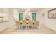 Bright dining room with large windows, modern chandelier, stylish decor and hardwood floors at 6090 River Chase Cir, Atlanta, GA 30328
