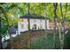Traditional two-story white home with black trim nestled on a wooded lot at 6090 River Chase Cir, Atlanta, GA 30328
