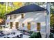 Stunning backyard view of the home with a patio, elegant outdoor furniture, and well-maintained landscaping at 6090 River Chase Cir, Atlanta, GA 30328