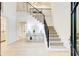 Bright foyer with elegant staircase, hardwood floors, iron railing, and stylish decor at 6090 River Chase Cir, Atlanta, GA 30328