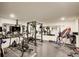 Spacious home gym with a variety of equipment, mirrored walls, and rubber flooring for effective workouts at 6090 River Chase Cir, Atlanta, GA 30328