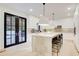 Modern kitchen with an island, barstool seating, sleek white cabinetry, and stainless steel appliances at 6090 River Chase Cir, Atlanta, GA 30328