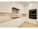 Modern kitchen with stainless steel appliances, sleek white cabinets, and stylish countertops at 6090 River Chase Cir, Atlanta, GA 30328