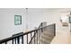 Bright staircase featuring a modern chandelier, black metal railing, and a view to the lower floor and the bedroom at 6090 River Chase Cir, Atlanta, GA 30328