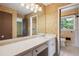 Bathroom with a long vanity, large mirror and tiled floors at 3089 Ranlo Dr, Atlanta, GA 30340