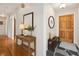 Inviting entryway featuring hardwood floors, console table, and slate flooring leading to a wooden front door at 3089 Ranlo Dr, Atlanta, GA 30340