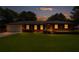 Charming brick home with a well-manicured lawn and inviting curb appeal at dusk at 3089 Ranlo Dr, Atlanta, GA 30340